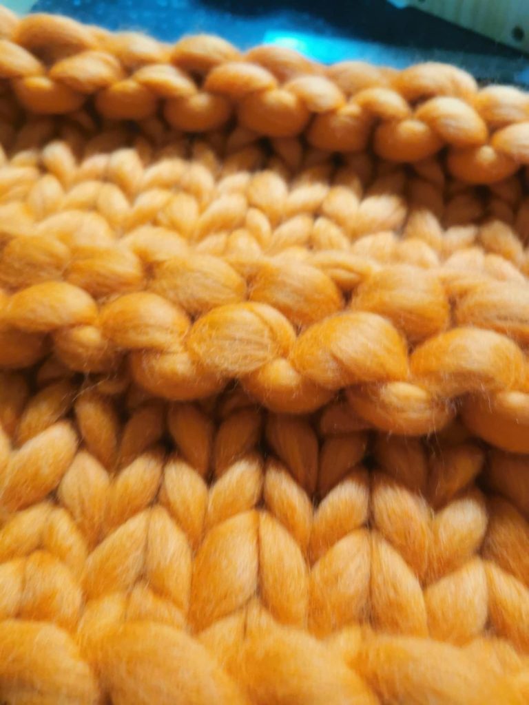 textured-orange-merino-wool-close-up Close-up of textured hand-knit blanket, double-strand detail, using orange merino wool from the Adventures in Wool at Bord Du Lac Artisan.