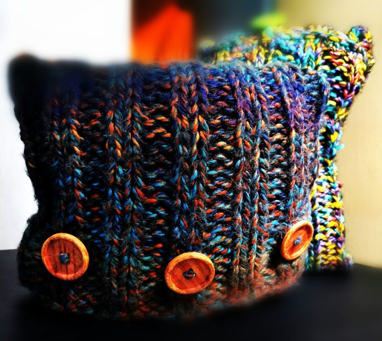 hand-knitted-cushion-with-big-buttons Unique hand-knitted textile with big wooden buttons from the Countryside Collection in the Adventures in Wool at Bord Du Lac Artisans.